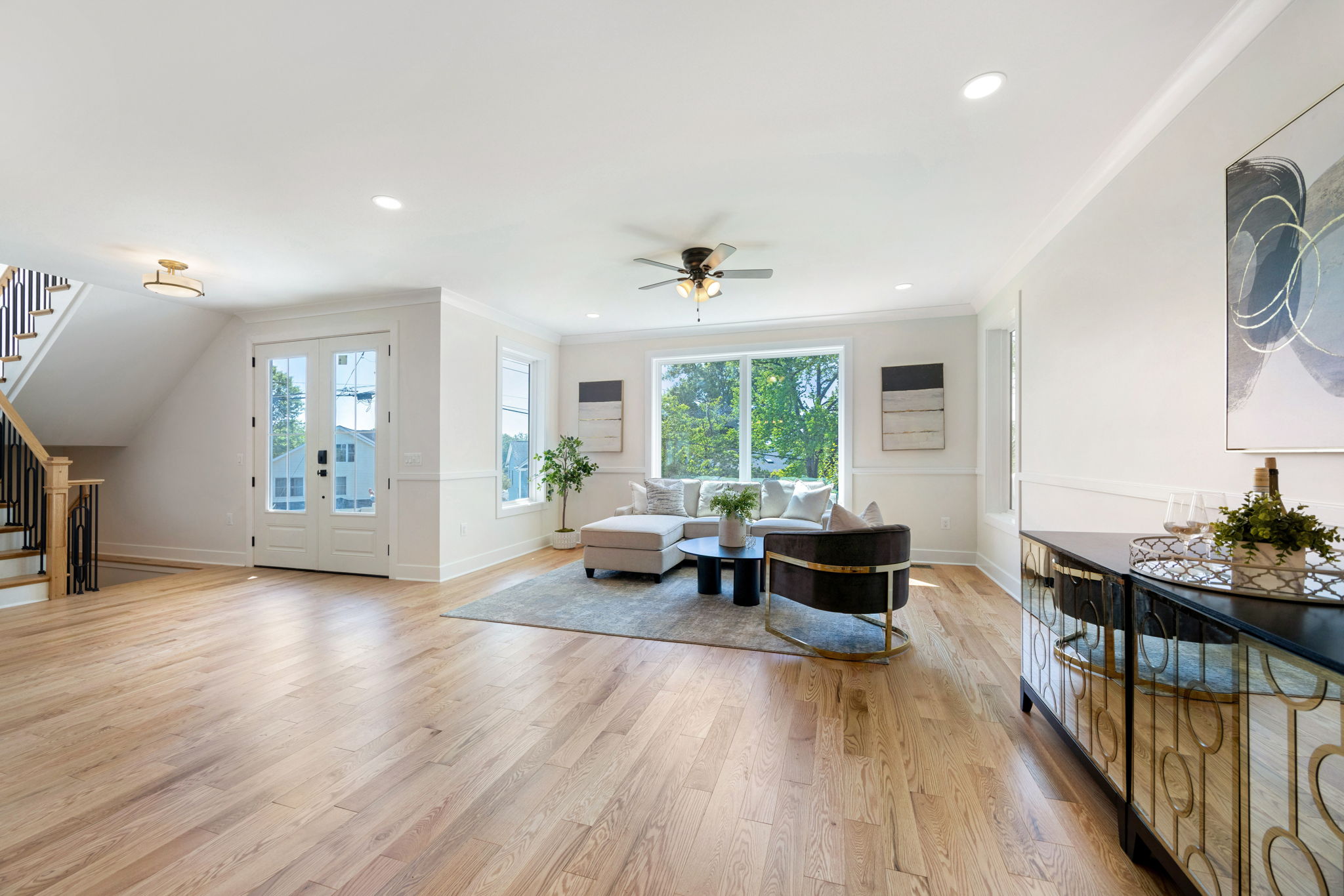 Living room with hardwood flooring and views toward the trees