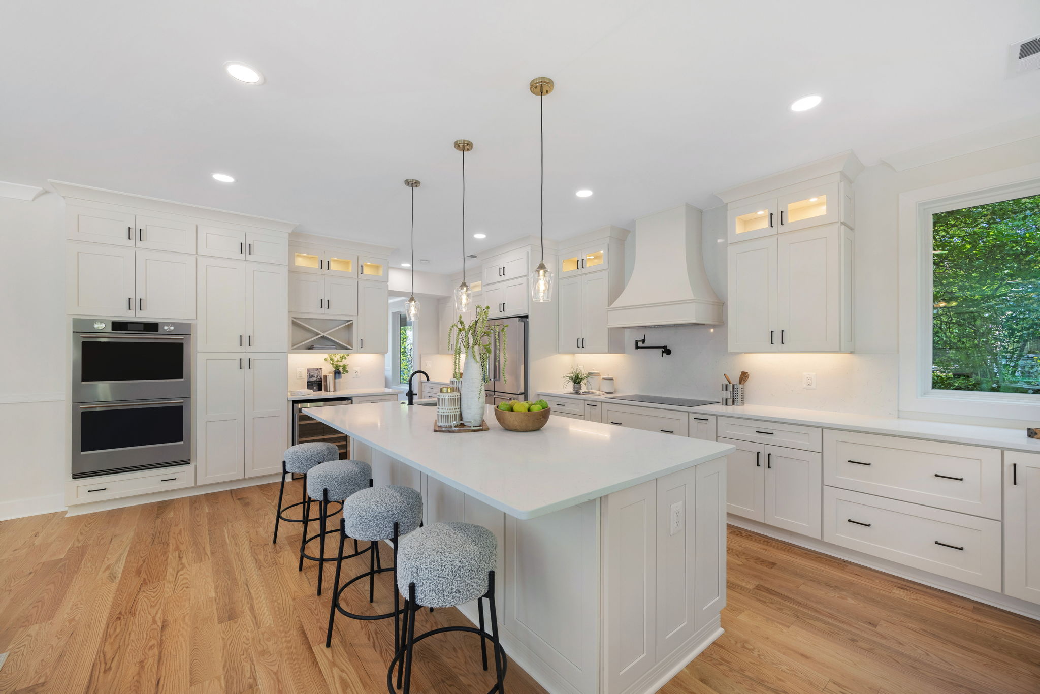 Kitchen with quartz island and double wall ovens